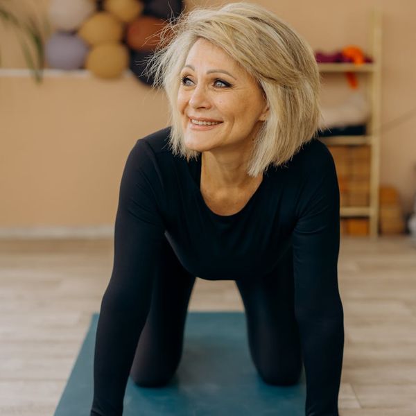 A person smiling and stretching after a workout, feeling energized.